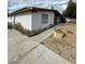 Side view of home featuring stucco exterior, landscaping, and walkway to the front porch at 1413 Bryn Mawr Ave, Las Vegas, NV 89102