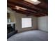 Bright living area featuring a wood-beamed ceiling, fireplace, and window, inviting natural light at 1413 Bryn Mawr Ave, Las Vegas, NV 89102