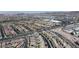 Wide aerial view displaying a community's layout, roadways, commercial buildings, and residential areas, offering a sense of scale at 156 Campbelltown Ave, Henderson, NV 89015
