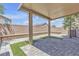 This covered patio boasts pavers, artificial turf, and a block wall for a private outdoor retreat at 156 Campbelltown Ave, Henderson, NV 89015