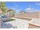 Backyard features pavers, artificial turf, a block wall, and a covered patio for outdoor living at 156 Campbelltown Ave, Henderson, NV 89015