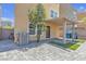 Charming backyard featuring pavers, artificial turf, a covered patio, and privacy wall at 156 Campbelltown Ave, Henderson, NV 89015