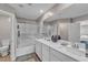 Bathroom featuring double sinks, a shower-tub combo, and wood-look floors for style and functionality at 156 Campbelltown Ave, Henderson, NV 89015