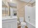 Clean bathroom features a tub with white tiled walls, a toilet, and vanity with a white cabinet at 156 Campbelltown Ave, Henderson, NV 89015