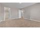 Spacious bedroom featuring three doors, neutral walls, and tan carpet at 156 Campbelltown Ave, Henderson, NV 89015