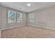 Neutral bedroom featuring three windows providing natural light and tan carpet at 156 Campbelltown Ave, Henderson, NV 89015