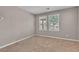 Bright bedroom features neutral walls, two windows, and plush carpeting for a cozy feel at 156 Campbelltown Ave, Henderson, NV 89015