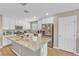Modern kitchen with white cabinets, stainless steel appliances, and a large granite island at 156 Campbelltown Ave, Henderson, NV 89015