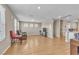 Bright, open living area with wood tile flooring, natural light, and space for customized seating arrangements at 156 Campbelltown Ave, Henderson, NV 89015