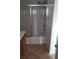 Shower with sliding glass doors, shower head, and tile flooring in a bathroom at 167 Desert Pond Ave, Henderson, NV 89002