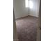 A cozy bedroom with neutral carpeting and natural light from the window at 167 Desert Pond Ave, Henderson, NV 89002