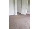 A bright bedroom with tan carpet and natural light coming in through the doorway at 167 Desert Pond Ave, Henderson, NV 89002