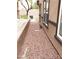 Narrow side yard with rock landscaping and the exterior of the property and windows at 167 Desert Pond Ave, Henderson, NV 89002