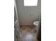 Toilet in a small room with tile floors and a window for natural light at 167 Desert Pond Ave, Henderson, NV 89002