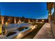 Night view of backyard oasis with ambient lighting and manicured landscaping at 182 Robledo St, Las Vegas, NV 89138