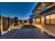 Backyard featuring stone patio, artificial grass, modern design, and ambient lighting at 182 Robledo St, Las Vegas, NV 89138