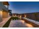 Backyard features built in bench, landscaped planters, and manicured synthetic lawn at 182 Robledo St, Las Vegas, NV 89138