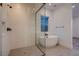 Bathroom features a glass shower enclosure, freestanding tub, and large window at 182 Robledo St, Las Vegas, NV 89138