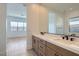 Bathroom featuring double vanity, modern fixtures, and views to bedroom and backyard at 182 Robledo St, Las Vegas, NV 89138