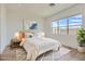 Serene bedroom with a comfortable bed, soft lighting, and a view of the outdoors at 182 Robledo St, Las Vegas, NV 89138