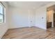 Bright bedroom boasts wood floors, a large window, and ensuite bathroom access at 182 Robledo St, Las Vegas, NV 89138