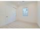Bedroom featuring neutral carpet, sliding closet doors, and a window overlooking the backyard at 182 Robledo St, Las Vegas, NV 89138