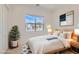 Bright bedroom with a comfortable bed, natural wood accents, and a large window at 182 Robledo St, Las Vegas, NV 89138