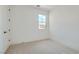 A minimalist bedroom with a view, enhanced by a bright window and white walls at 182 Robledo St, Las Vegas, NV 89138