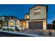 Charming two-story home featuring a well-manicured front yard, a beautiful archway, and a two-car garage at 182 Robledo St, Las Vegas, NV 89138