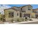 Charming two-story home featuring a well-manicured front yard, a beautiful archway, and a two-car garage at 182 Robledo St, Las Vegas, NV 89138