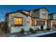 Charming two-story home featuring a well-manicured front yard, a beautiful archway, and a two-car garage at 182 Robledo St, Las Vegas, NV 89138