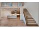 Open-concept living space with hardwood floors, flowing into a modern kitchen with island at 182 Robledo St, Las Vegas, NV 89138