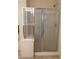 Modern bathroom featuring a glass-enclosed shower and tiled flooring at 206 Valerian St, Henderson, NV 89015
