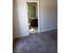 Partial view of a half bathroom featuring a single vanity, mirror, and toilet with tile flooring at 206 Valerian St, Henderson, NV 89015