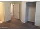 Neutral bedroom featuring carpet, an open closet with sliding doors, and access to an attached bathroom at 206 Valerian St, Henderson, NV 89015