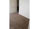 Neutral bedroom featuring carpet, access to an attached bathroom, and freshly painted white walls at 206 Valerian St, Henderson, NV 89015