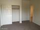 Bright bedroom featuring a closet with sliding doors, neutral carpet, and an attached bathroom at 206 Valerian St, Henderson, NV 89015