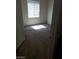 Bright bedroom featuring a window with blinds and neutral carpeting at 206 Valerian St, Henderson, NV 89015