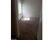 Bright bedroom featuring neutral carpet, bright natural light from the window with blinds, and freshly painted white walls at 206 Valerian St, Henderson, NV 89015