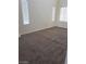 Spacious bedroom featuring neutral carpet, bright natural light, and freshly painted white walls at 206 Valerian St, Henderson, NV 89015
