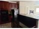 Kitchen with dark countertops and cabinetry, and black appliances offering functionality at 206 Valerian St, Henderson, NV 89015
