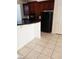 Modern kitchen featuring dark cabinets, black appliances, and tile flooring for a sleek design at 206 Valerian St, Henderson, NV 89015