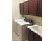Laundry room with washer, dryer, deep sink, and wood cabinets above at 206 Valerian St, Henderson, NV 89015