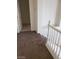 Carpeted staircase with white railing, leading to a tiled floor at 206 Valerian St, Henderson, NV 89015