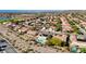 Aerial shot featuring a home with a backyard pool, solar panels, and a desert landscape at 2261 Evening Lights St, Henderson, NV 89052