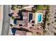 Top-down view of a home showcasing a swimming pool, patio, solar panels, and desert landscaping at 2261 Evening Lights St, Henderson, NV 89052