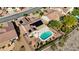 An aerial view of the house with a swimming pool, patio, solar panels, and desert landscaping at 2261 Evening Lights St, Henderson, NV 89052