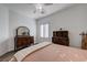 Bright bedroom featuring wood-look floors, neutral walls, plantation shutters, and a comfortable bed at 2261 Evening Lights St, Henderson, NV 89052