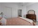 Inviting bedroom with wood-look floors and neutral walls plus a closet with sliding doors at 2261 Evening Lights St, Henderson, NV 89052