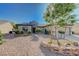 This lovely single-story home has a beautifully designed desert rock landscaped front yard at 2261 Evening Lights St, Henderson, NV 89052